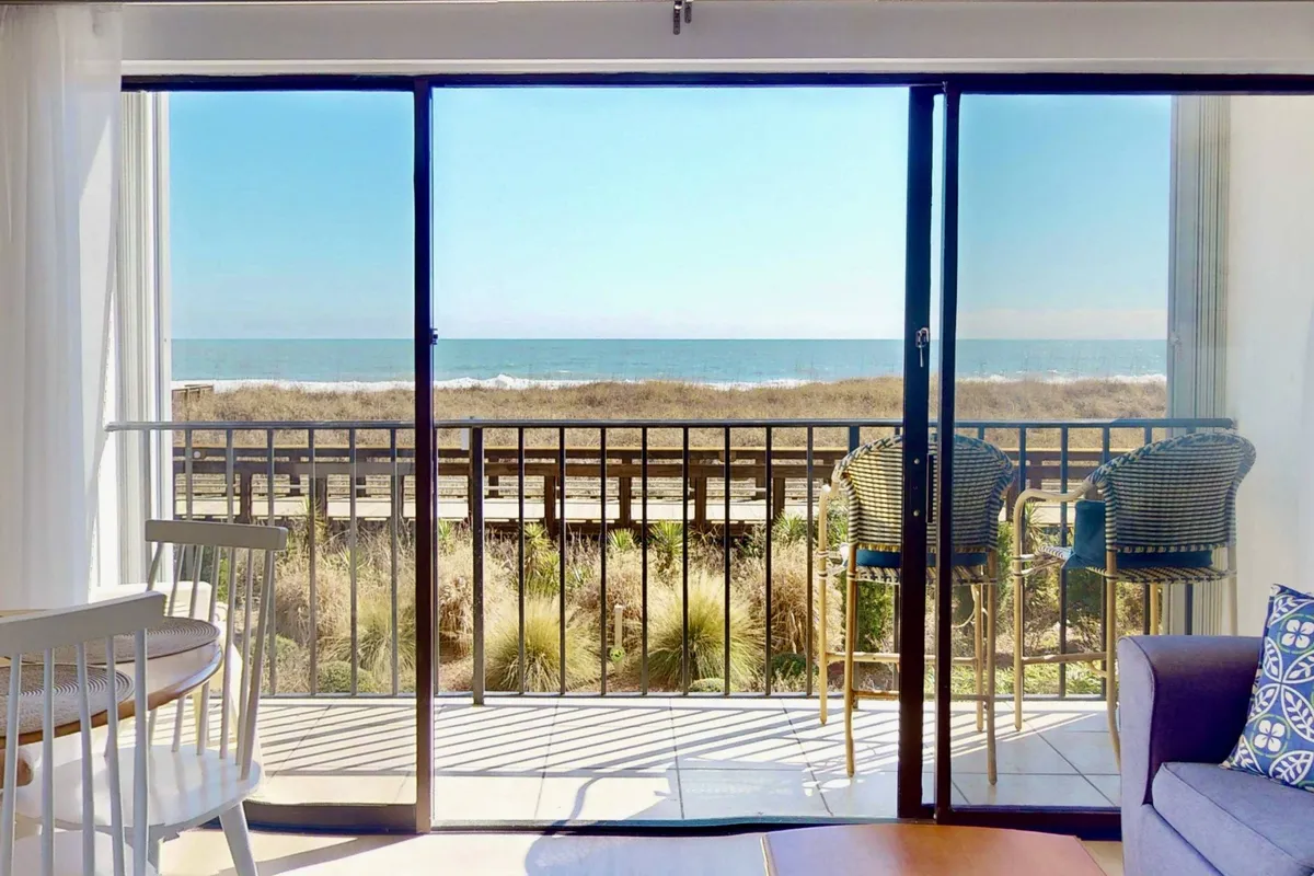 A tranquil balcony scene with seating that faces sweeping ocean views and a natural landscape. The space is ideal for enjoying morning coffee, reading a book, or watching the sunset.